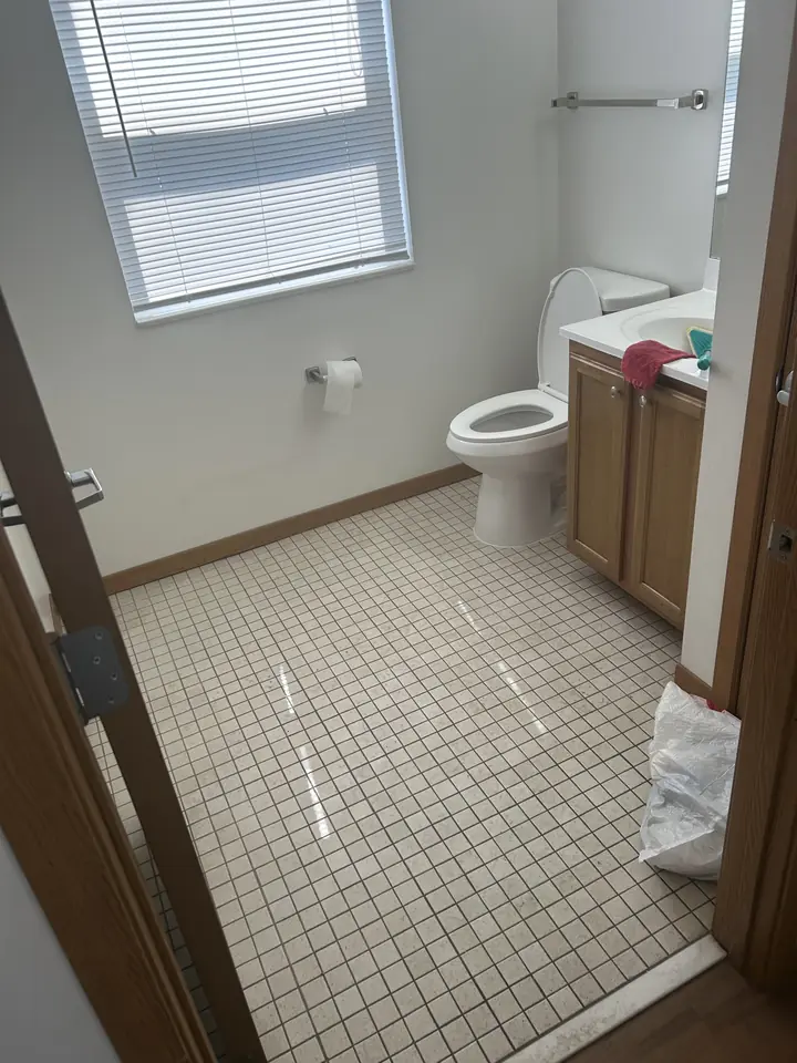 Bathroom before a Fresh Start cleaning in St. Louis, MO — floor tile, fixtures and surfaces
