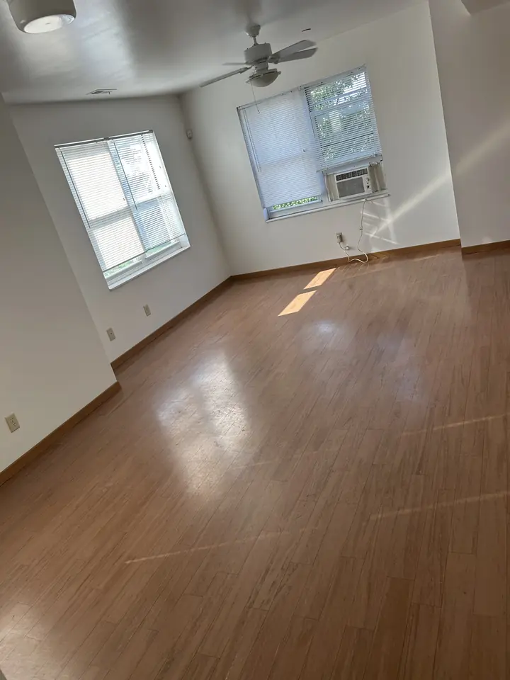 Bedroom after a Fresh Start cleaning in St. Louis, MO — hard floors and baseboards