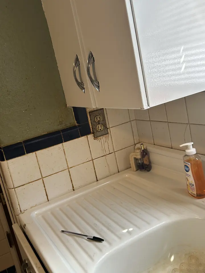 Kitchen before a Fresh Start cleaning in St. Louis, MO — sink, counter and backsplash
